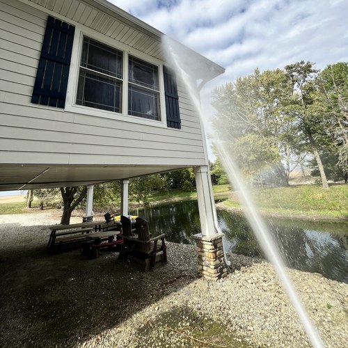 Soft washing a home's gutters, soffits and upper siding
