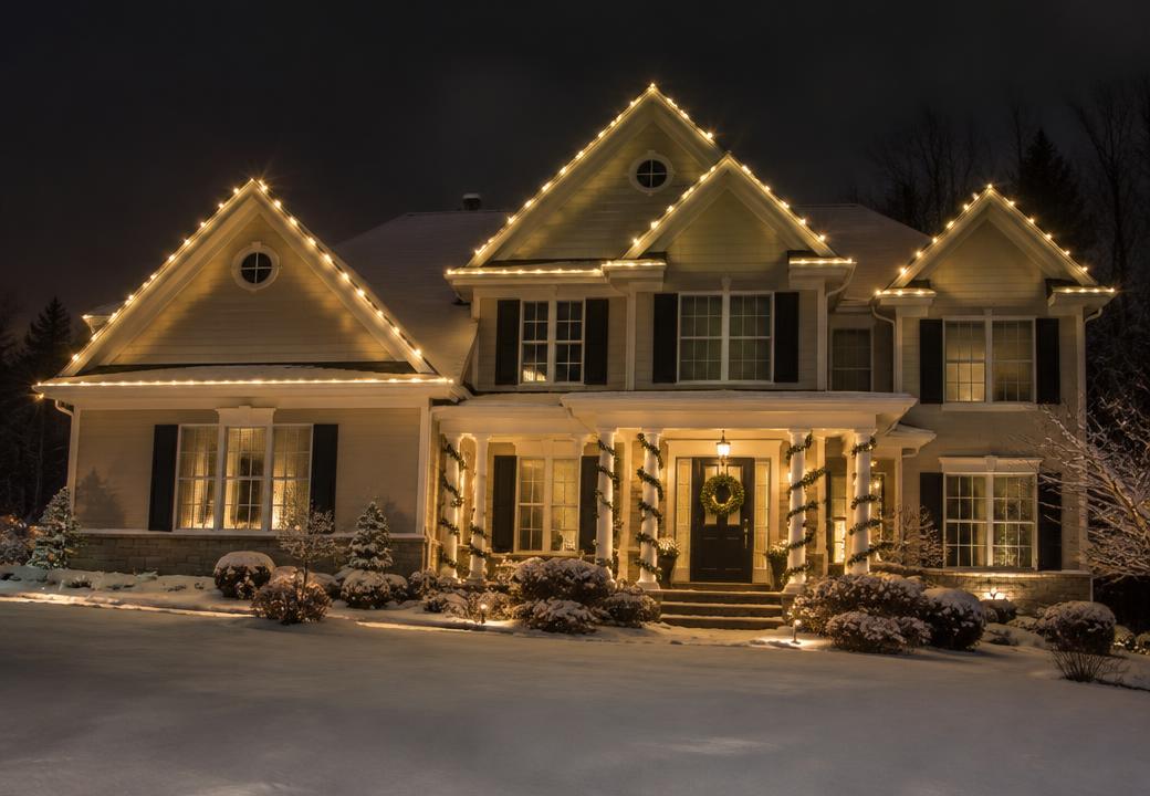 Colonial home with Christmas lights outlining every gable